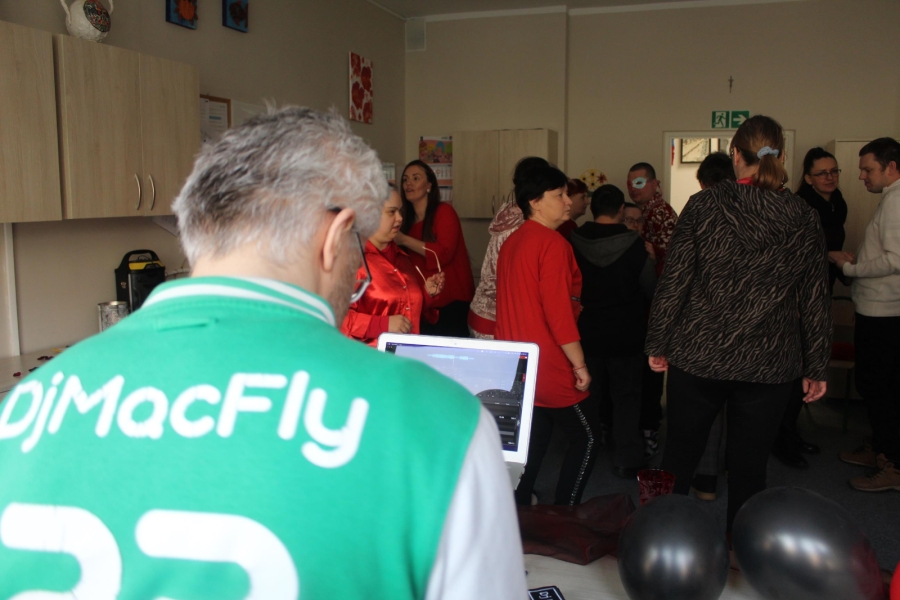 2.Prowadzący imprezę w bluzie z napisem DjMacFly puszczający muzykę tańczącym osobom