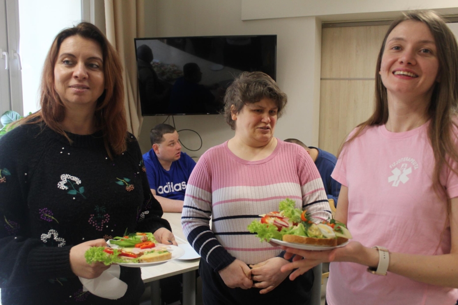 4.Psycholog oraz fizjoterapeuta prezentujący kanapki na talerzach