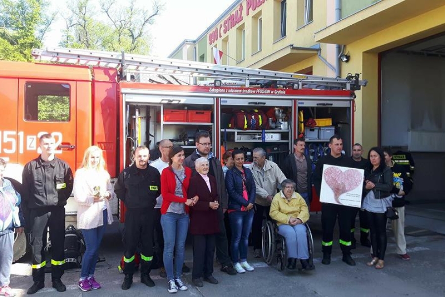 Zdjęcie grupowe uczestników na tle wozu strażackiego