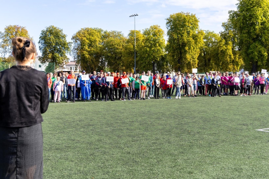 9.Fizjoterapeutka przemawiająca do dużej grupy uczestników na boisku 