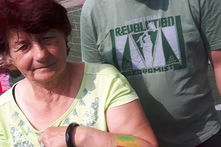 Dwoje uczestników pozujących do zdjęcia przed bramką piłkarską 