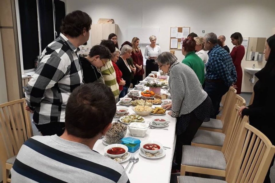 Uczestnicy podczas przemówienia wigilijnego przy stole