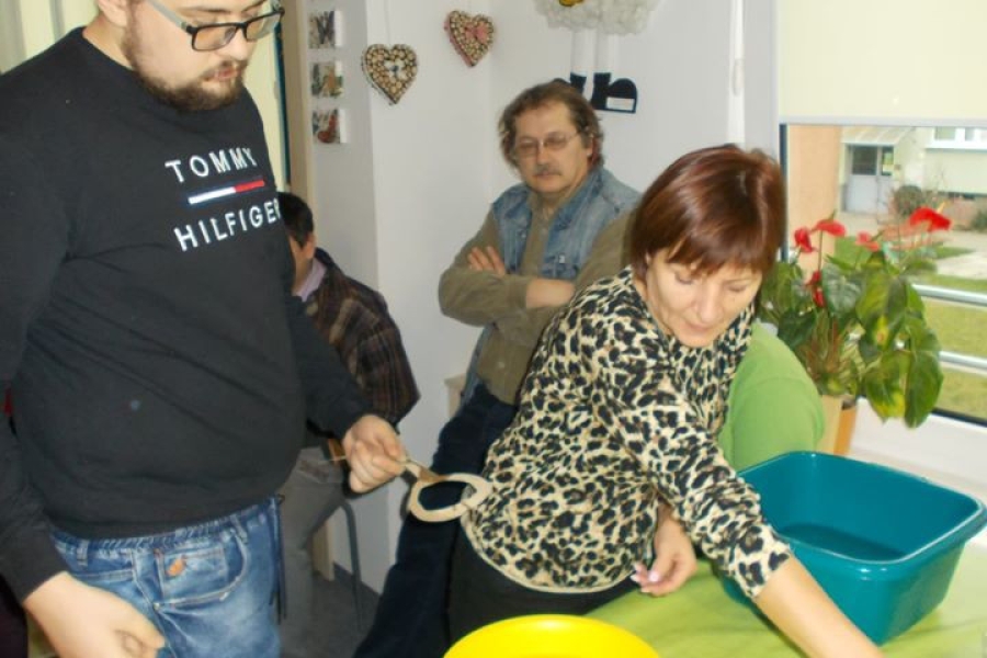 Uczestnik przelewający wosk w asyście terapeuty