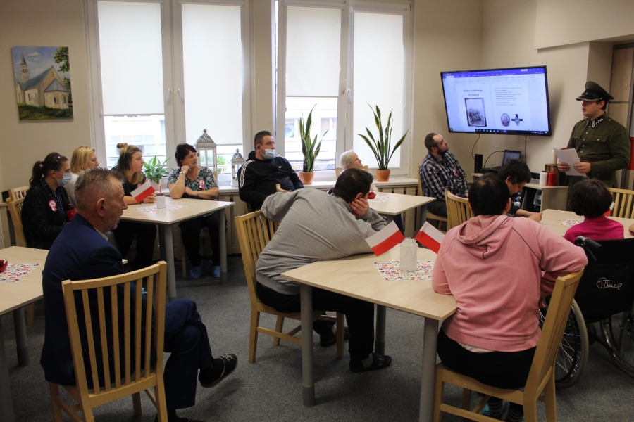 2- Grupa Uczestników słucha prelekcji Pana Macieja ubranego w mundur.